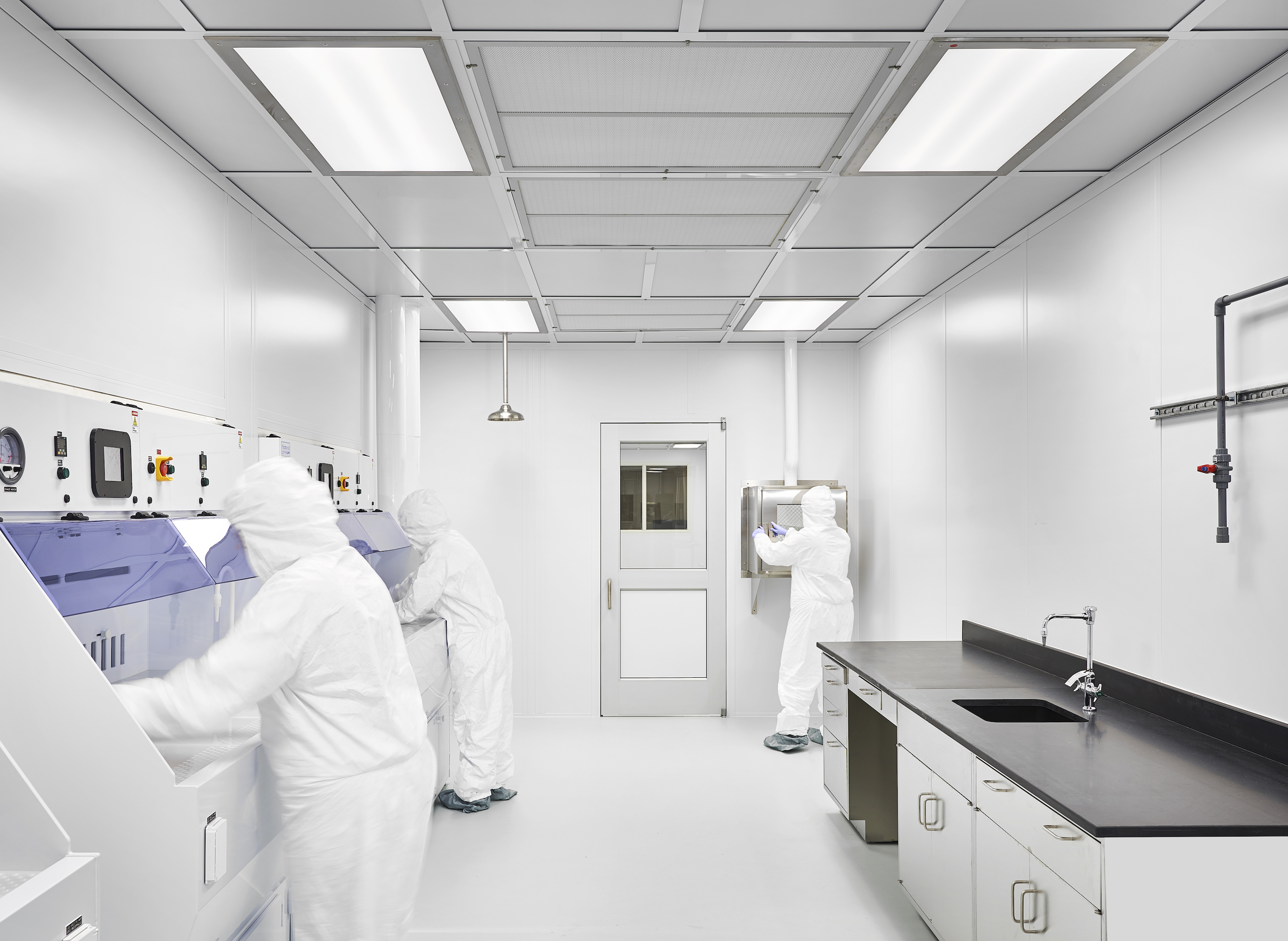 Three students working in the laboratory. 